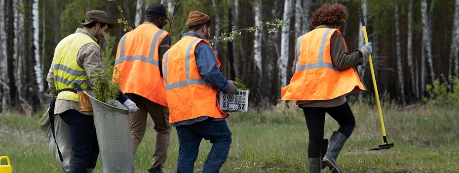 Community members holding a meeting under trees